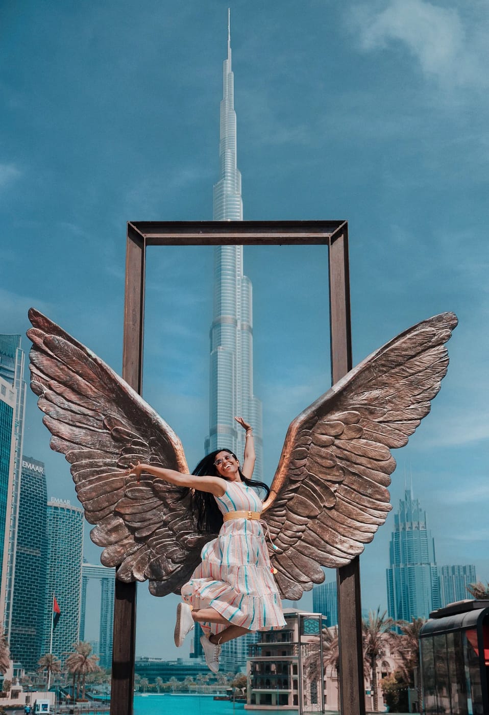 Sanmita in front of Wings of Mexico art installation, Burj Khalifa Dubai, adventure travel portrait